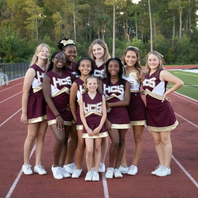 The HCS cheer team on a track.