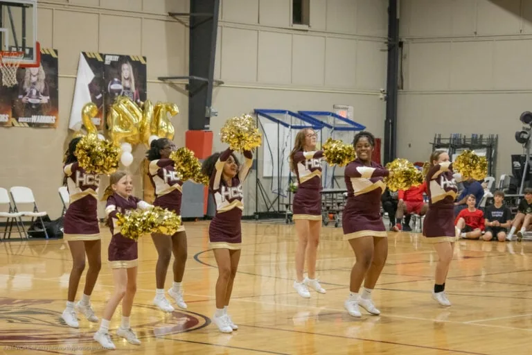 Cheer team cheering at a basketball game.