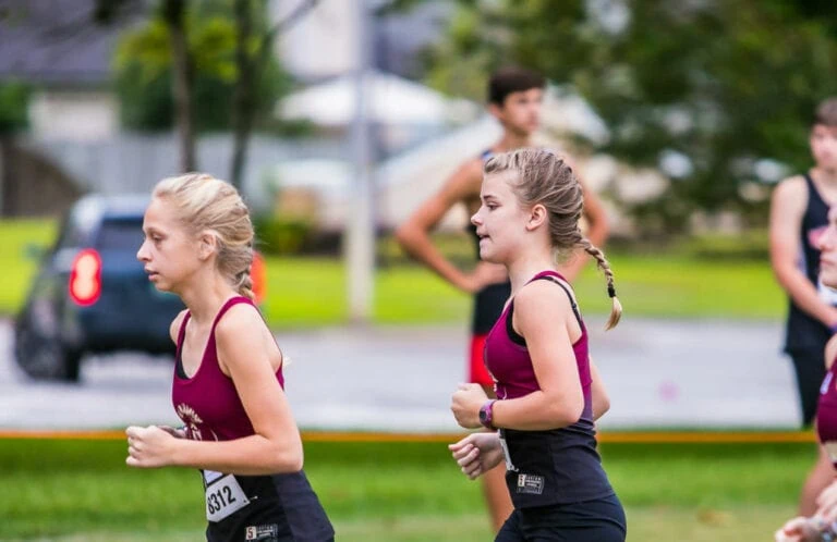 Girls cross country team running.