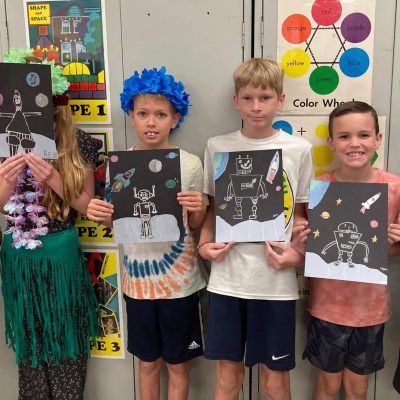 Kids with art projects.